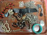 a tray that has many different types of jewelry on it