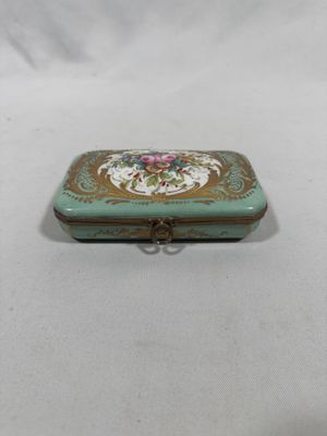 an image of a small green box with a pink flower on it