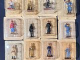 a lot of plastic figurines of people in plastic containers