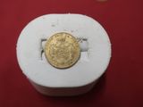a gold coin sitting on top of a white object