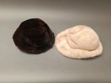two hats that are sitting next to each other on a table