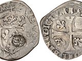 a silver coin with a shield on the front and a shield on the back