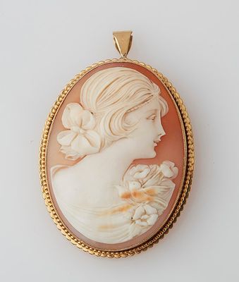 an image of a woman with a flower in her hair is shown in a pendant
