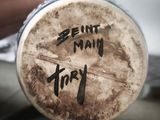 a person holding a beer glass with writing on it