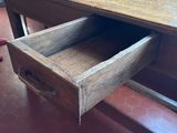 a wooden desk with a drawer underneath it