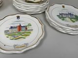 several plates with a picture of a castle on them sitting on a table