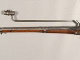 an old gun with a wooden barrel and a metal handle