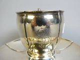 a silver cup and saucer on a saucer on a saucer