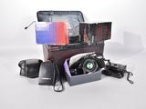 a suitcase with a camera and other items in it