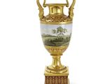 un vase en or orné d'un paysage