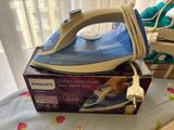 a blue and white iron sitting on top of a box