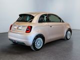the small car is parked in the large room of the building