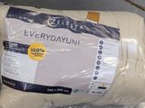 a pillow that is wrapped in plastic on the floor