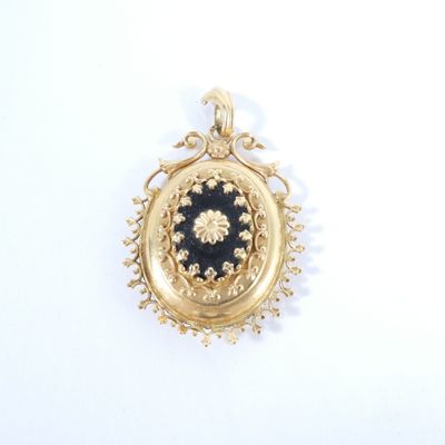 an image of a gold locke with a black stone in it