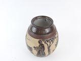 a small vase with a picture of a woman and a tree on it