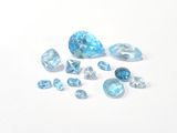 a group of blue topazte gems on a white surface