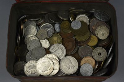 a lot of coins in a box on the table