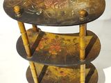 a three tiered table with a floral design on it