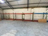 a large warehouse with a lot of shelves in the middle of the room
