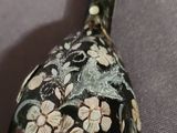 a close up of a spoon with a flower design on it