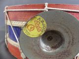 a drum with a sticker on it sitting on a table