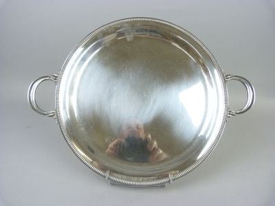 a silver tray with handles and handles on a table