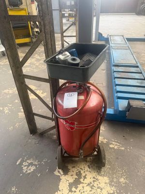 a red fire extinguisor sitting on a cart in a warehouse