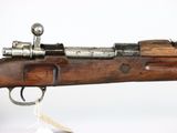 a close up of a rifle on a white background with a tag