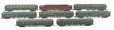 a lot of green and red train cars on a white surface