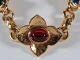gold plated bracelet with red, green, and blue stones