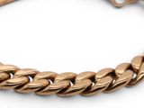 a close up of a gold bracelet on a white background