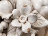 a white vase with a bunch of flowers in it