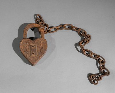 a heart shaped padlock attached to a chain