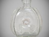 a clear glass bottle with a ring inside of it