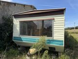 a small trailer that is sitting in the grass