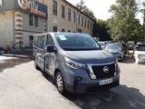 a grey van parked in front of a building
