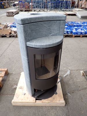 a stove that is sitting on a pallet in a warehouse