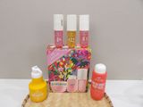 a basket with a lot of cosmetics and a bottle of liquid on it