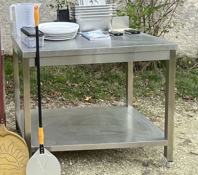 a silver table with a shovel and a bowl on it