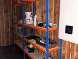 a room that has a shelf with a lot of items on it
