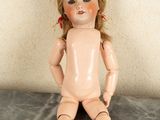 a doll that is sitting on a marble table