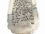 a silver spoon that has a design on it
