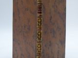 a brown book with gold trim and a brown cover