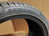 a close up of a tire on a cardboard box with a box in the background