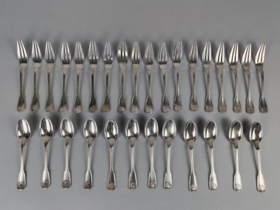 a group of silver spoons and forks on a gray surface