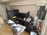 a desk with a chair and a computer on it