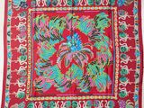 a red banda with colorful birds and flowers on it