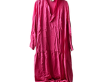 pink long dress hanging on a hanger on a white wall