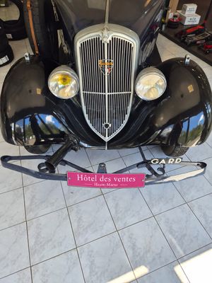 a black car that is on display in a showroom