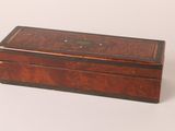 a small wooden box with a lid on a white surface